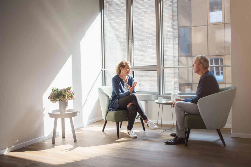 Therapeutin spricht mit Patientin und nutzt holzblock steine.